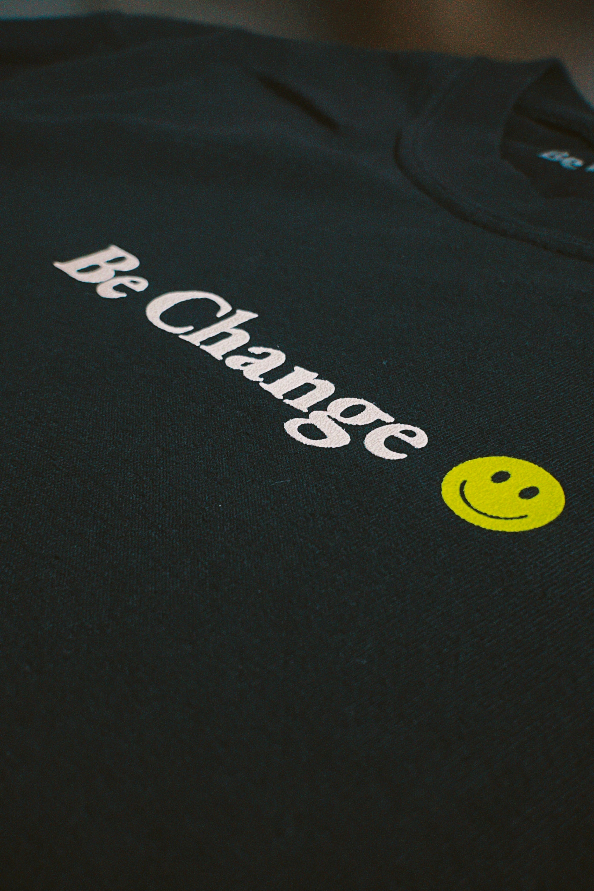 Be Change Definition Tee Front/Black Close Up Smiley Face